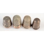 A small silver thimble, possibly Georgian, together with three other thimbles.