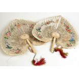 A pair of 18th century Chinese feather decorated fans painted with figures,