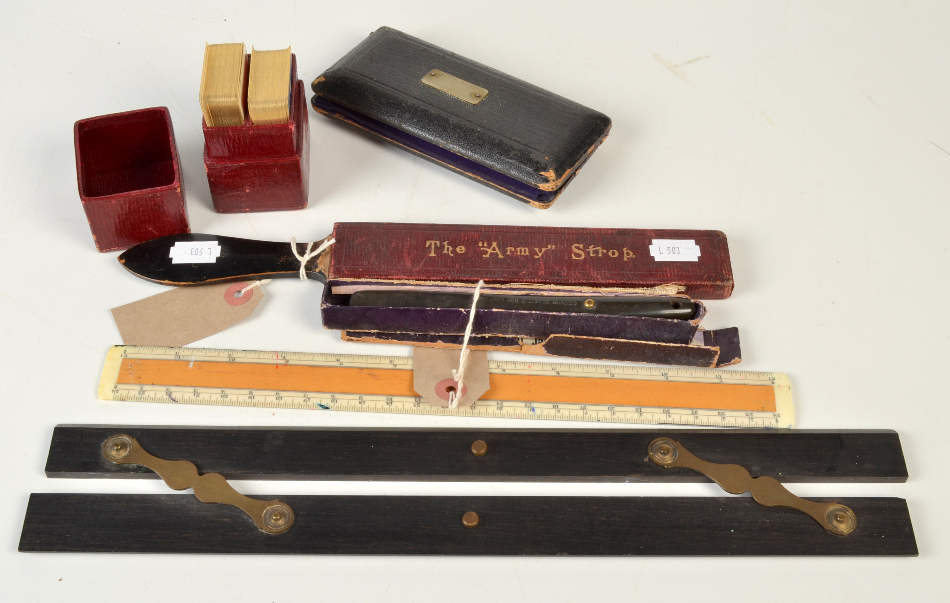 An early 20th century Gillette 'Safety Razor Blade Stropper' and Army Strop, a parallel rule,