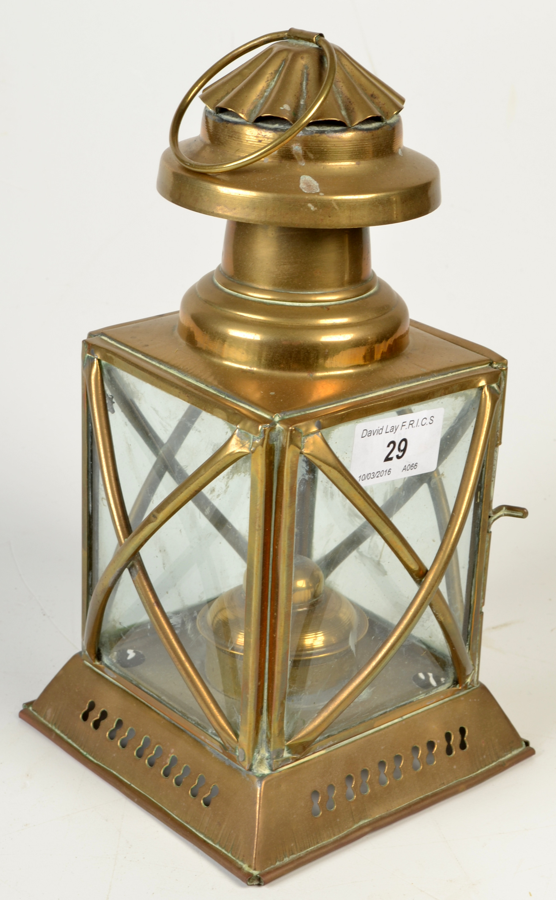 A square brass paraffin lantern, height excluding suspension ring 24cm.