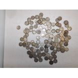 A quantity of silver 3d pieces.