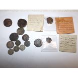 A collection of coins, three with old identification envelopes,