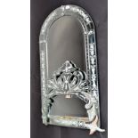 A Venetian style arched, reverse cut mirror with bevelled glass and crested mount,