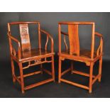 A pair of Chinese chairs the wood in Huanghuali style, each chair with a plain central splat,