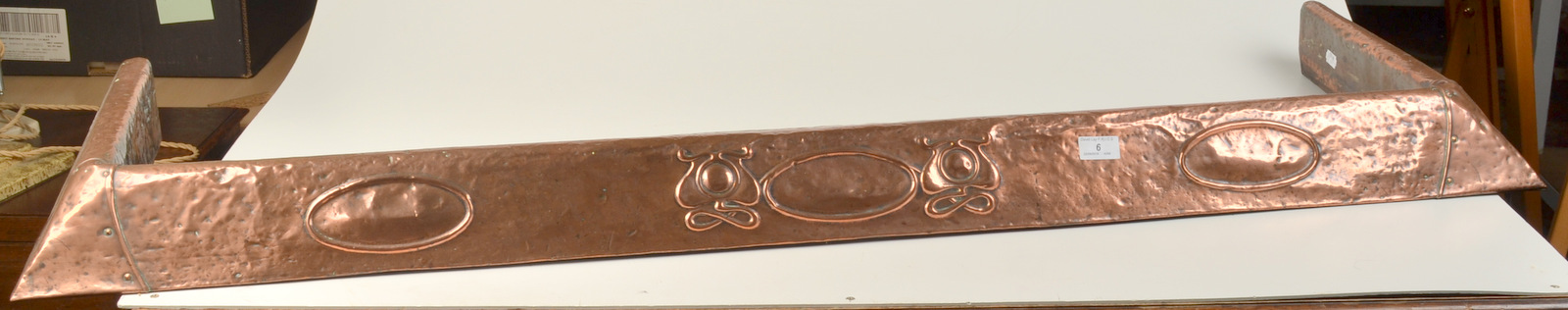 An Art Nouveau Hayle copper clad fire kerb, length 138cm.