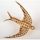 A good very high purity gold swallow brooch pave set with pearls.