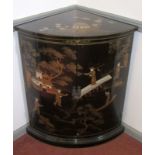 An oriental lacquered standing corner cupboard.