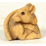 A bone netsuke of a seated rat, in Kyoto style, 19th century, height 3cm, width 3cm.