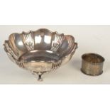 A pierced silver bon bon basket on three legs and silver napkin ring, 4oz.