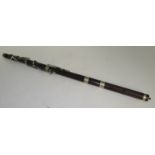 A rosewood flute with nickel keys and rings, length including finial 68.5cm.