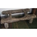 An 18th century wheelwright's wooden trestle standing on four substantial legs, width 58cm,