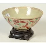 A 16th/17th century Swatow porcelain bowl decorated with flower sprays in over glaze red and green,