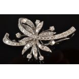 A 14ct. white gold and diamond floral bow brooch.