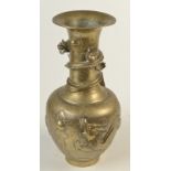 A Chinese late 19th/early 20th century brass vase with dragon motifs curling around the body,