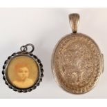 A Victorian engraved silver locket and a pendant.