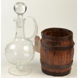 A small iron banded, oak barrel and a claret jug.