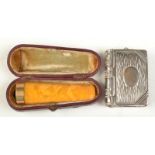 A nickle vesta case/ stamp case in the form of a book together with an amber cheroot holder, cased.