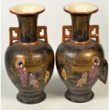 A pair of Japanese Satsuma vases, the black ground with gilt decorated pagodas,