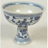 A blue and white stem cup, decorated with a floral motif and key border, the height 11.