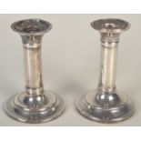 Two early 20th century filled silver candlesticks, height 11cm.