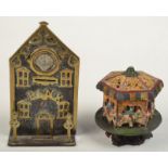 A Victorian brass and steel 'Bank' money box made as a steepled clock tower with a clock face in