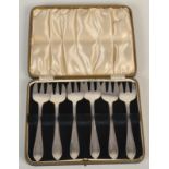 A set of six George V silver cake forks, cased.