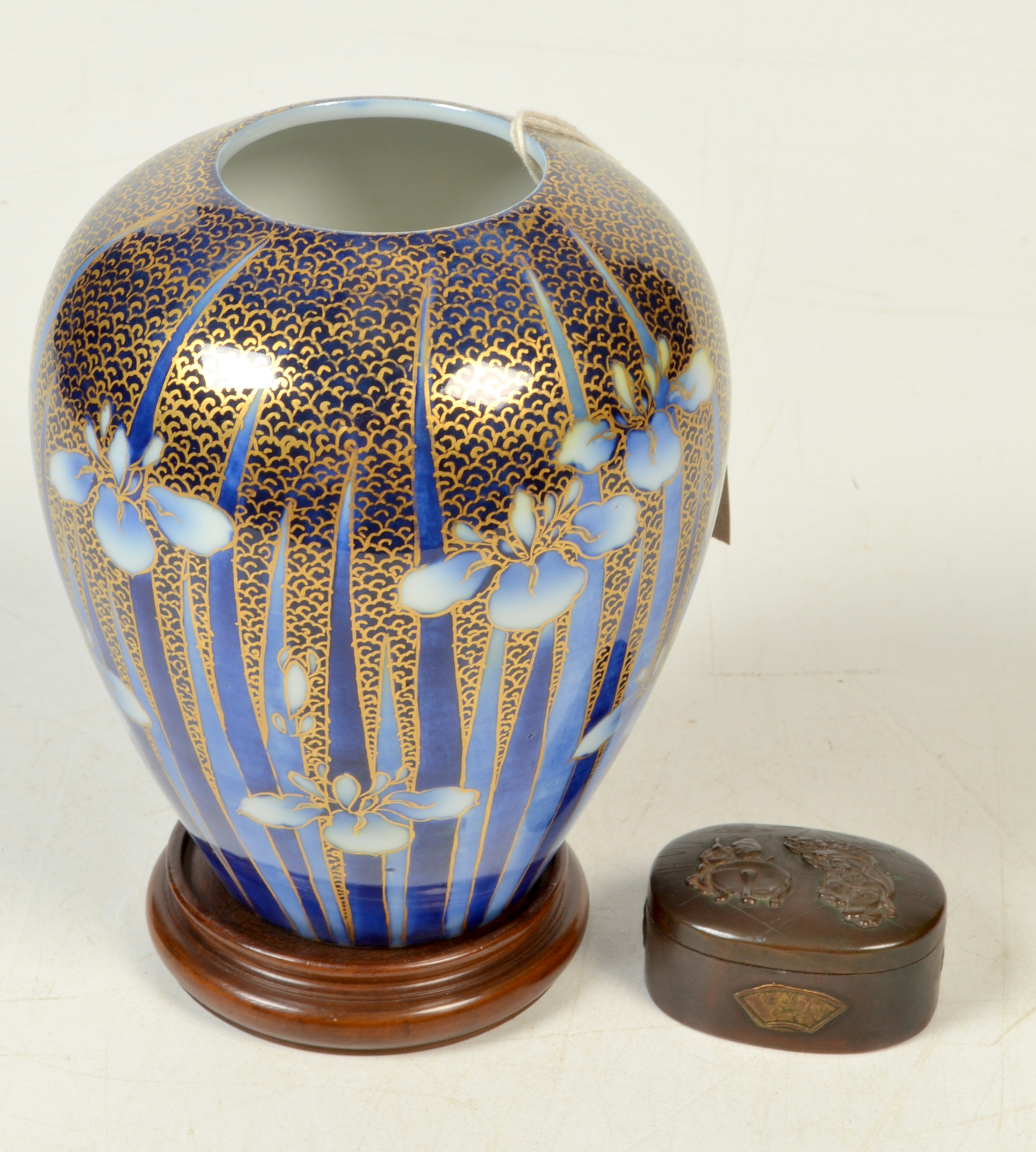 A Fukagawa iris decorated vase with hardwood stand, maximum height 16cm,