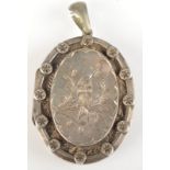 A Victorian engraved silver locket.