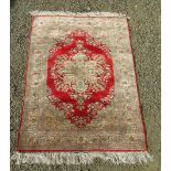 A Turkish silk and gold metal thread rug, with double signature cartouche,