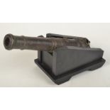 A Brunei bronze small cannon, cast with a flower touch hole and tapering banded barrel,