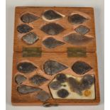 An oak box containing flint arrowheads and microliths,