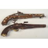 Two reproduction percussion cap pistols and a similar flintlock.