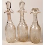 A set of three Victorian cut glass decanters with two matching stoppers and a dissimilar stopper.