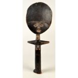 An Ghanian Ashanti (Akuara) carved wood fertility doll, height 62.5cm, together with a Kodak camera.