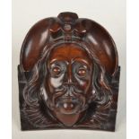 A carving, the head of a man in 16th century style with long hair, a moustache and ruff, width 14cm,