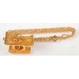 An Ashanti high purity gold filigree pendant in the form of a traditional stool with chain, 9g.