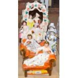 A pair of Staffordshire figures each on a chaise longue,