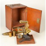 A brass and iron microscope with mahogany case fitted with a slide drawer.