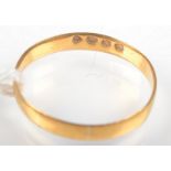 A 22ct. yellow gold band. 1.