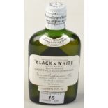 A 1950's/60's Black & White Buchanan's 6 2/3 fluid oz. bottle of whisky.