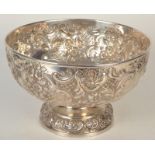 A late Victorian repousse decorated footed punch bowl by Wakely and Wheeler, London 1896, 29oz,