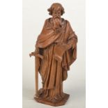 An oak carving of Saint Paul, the bearded robed figure with a scroll in one hand,