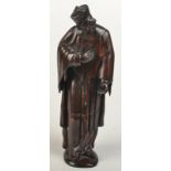 A French 18th/19th century carved wood figure of a bearded churchman wearing a biretta,