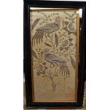 An Indian silk and silver metal thread embroidered panel decorated with exotic birds perched on a