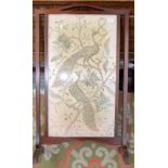 An Indian silk and silver metal thread embroidered firescreen depicting peacocks and snakes on