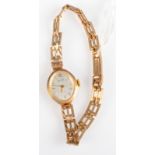 A 9ct. gold cased ladies wrist watch on 9ct. gold gate link bracelet. 10.