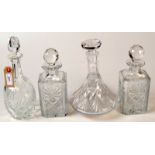 A pair of cut glass square section decanters, a ship's decanter and one other decanter.