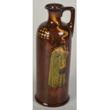 A Royal Doulton Kingsware flask designed by Noke in the Wizard pattern, height 24.5cm.