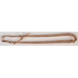 A curb link 9ct. gold pocket watch chain, 34.1g.