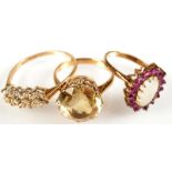 A gold dress ring set of citrine and two other gold dress rings.